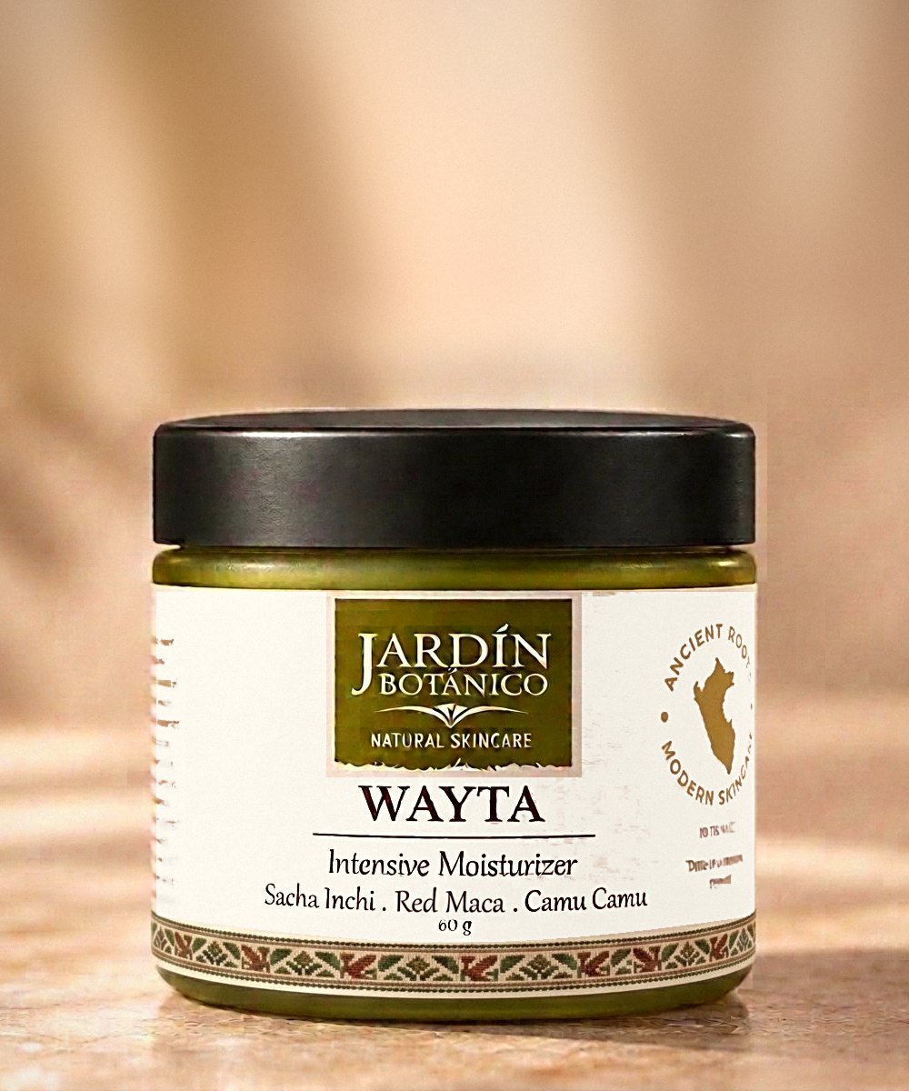 Wayta facial moisturizer in a green glass jar with a black lid and an Andean ribbon on its label